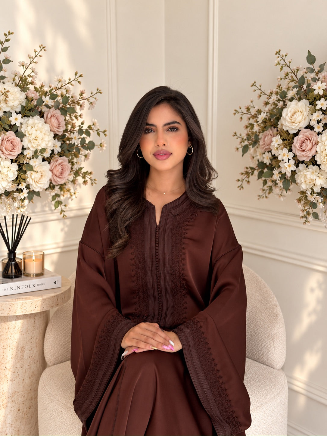 Model seated in chocolate-brown dra de soie Gandoura Ritaj with tonal embroidery along the neckline and sleeves
