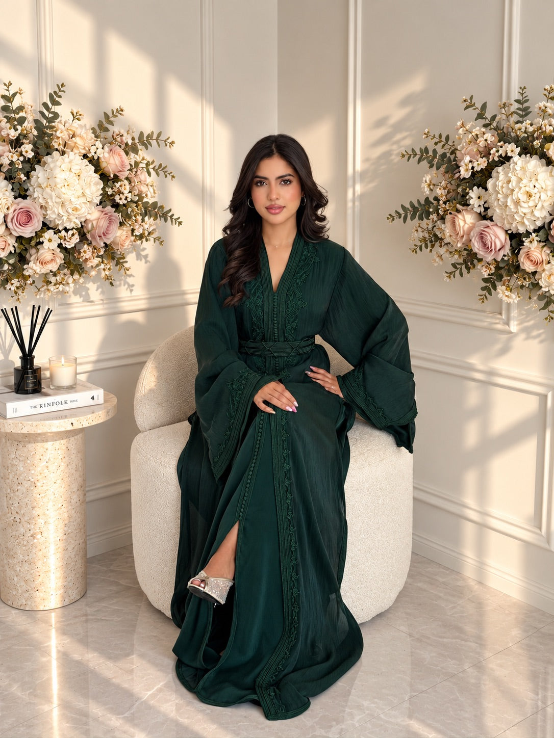 Full-length seated view of deep green Moroccan Takchita Ayah with a flowing skirt and matching belt