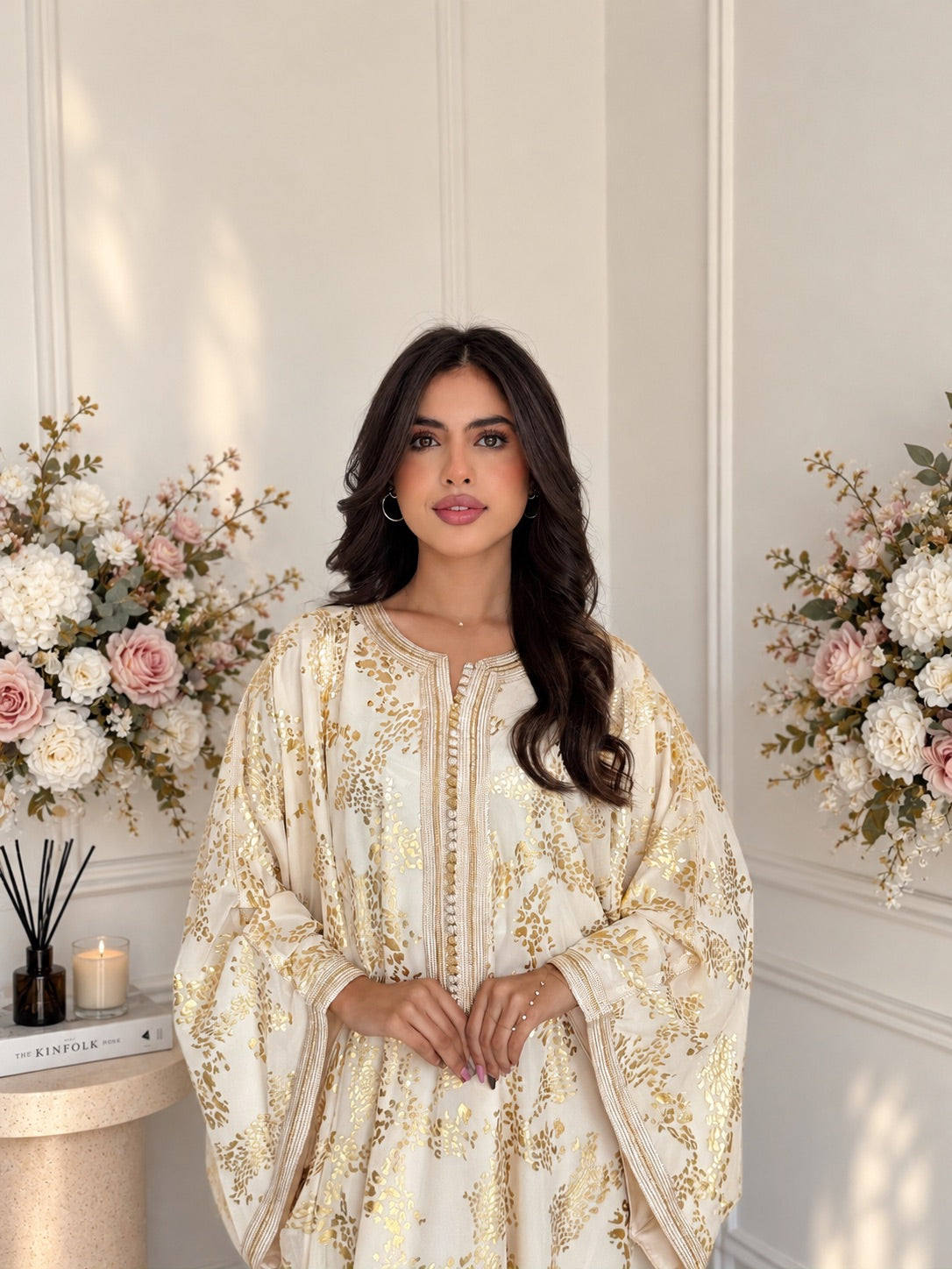Front view of Gandoura Ameera, an ivory and gold Moroccan dress with a flowing silhouette