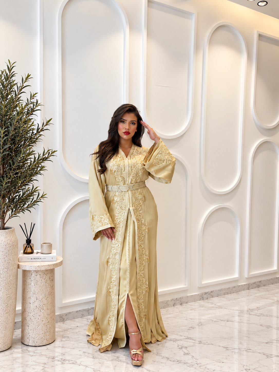 Full-length view of Takchita Dahab, a gold two-piece Moroccan organza dress with embroidery and matching belt