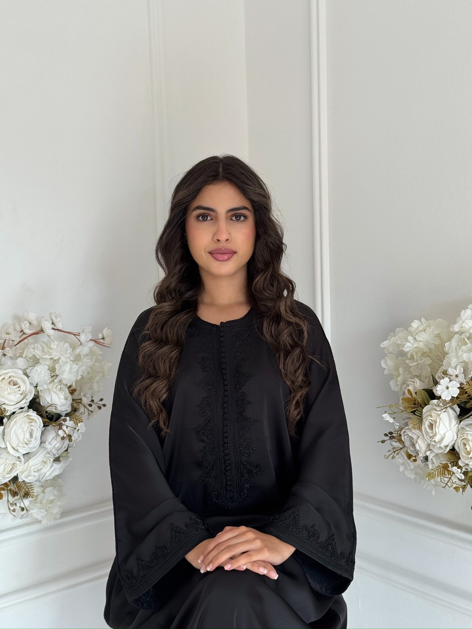 Model wearing the black Gandoura Nihal Moroccan dress in drap de soie silk
